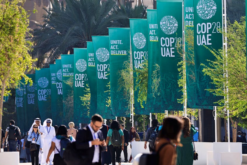 Delegates walk at the United Nations Climate Change Conference COP28 in Dubai, United Arab Emirates, December 8, 2023.