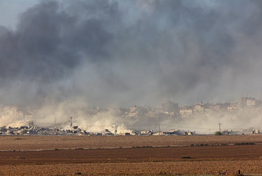Smoke rises over Gaza, amid the ongoing conflict between Israel and the Palestinian Islamist group Hamas, as seen from southern Israel, December 9, 2023.