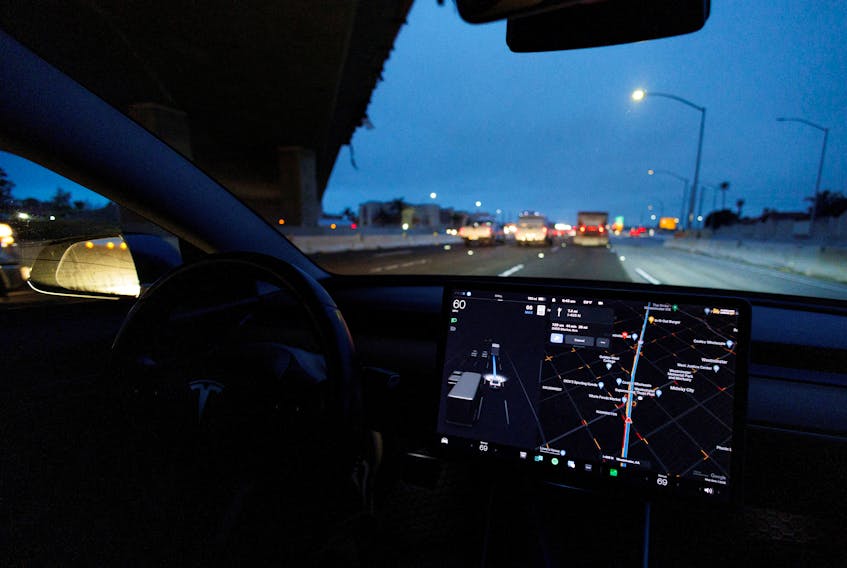 A Tesla Model 3 vehicle drives on autopilot along the 405 highway in Westminster, California, U.S., March 16, 2022.