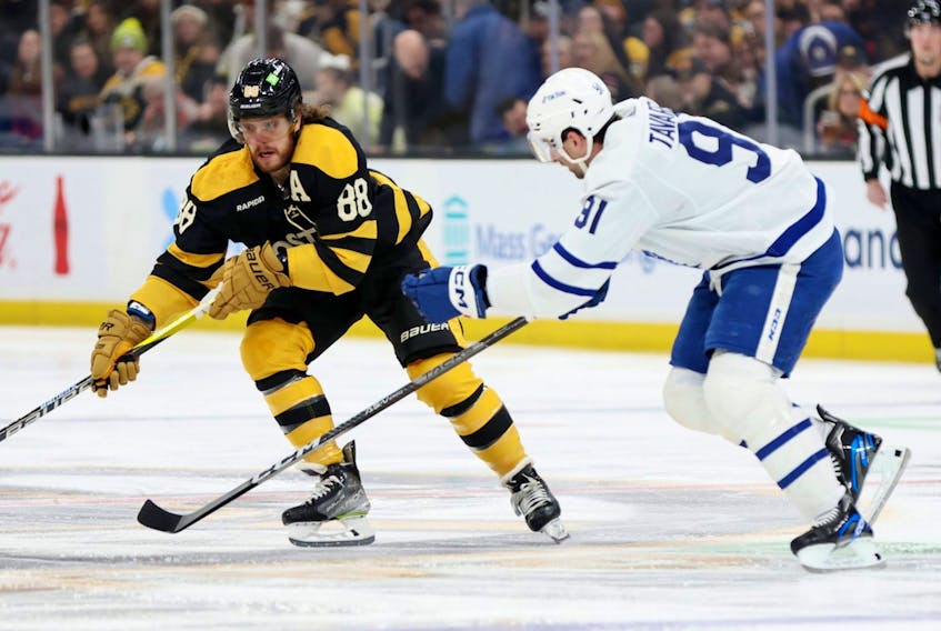 David Pastrnak #88 of the Boston Bruins skates against John Tavares #91 of the Toronto Maple Leafs during the first period at TD Garden on January 14, 2023 in Boston.