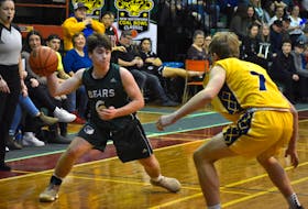 Joe MacNeil of the Breton Education Centre Bears, left, looks to make a pass as he's watched closely by Peyton White of the Hants North Flames during Day 2 of the New Waterford Coal Bowl Classic at the BEC gym in New Waterford on Tuesday. BEC won the game 77-43. JEREMY FRASER/CAPE BRETON POST.