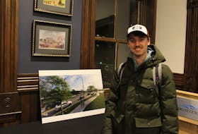 UPEI phycology student, Max MacDonald reviews renderings of what the proposed changes to University Avenue might look like. As a cyclist he supports the addition of a mulit-use active transportation pathway. George Melitides • The Guardian