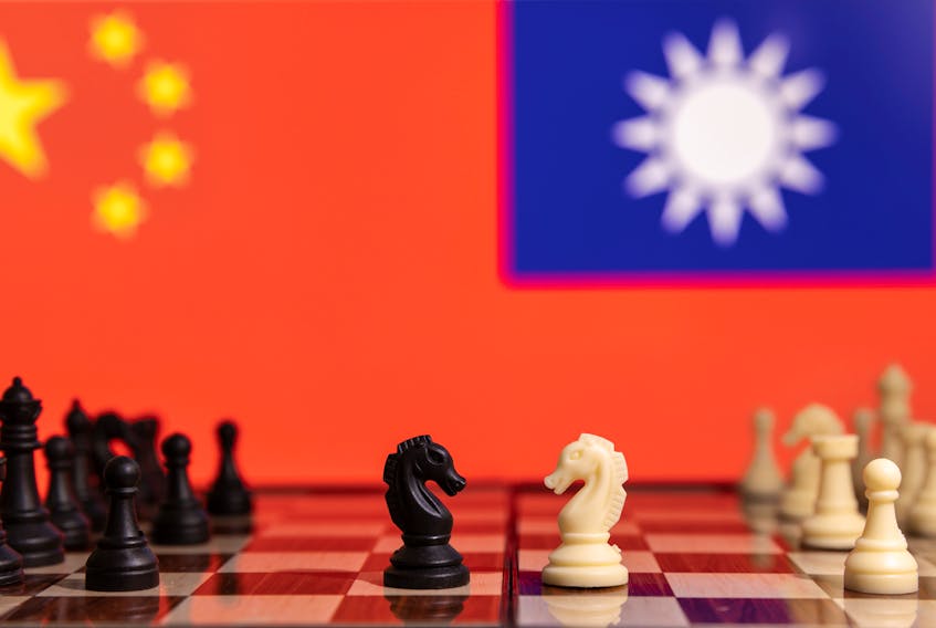 Chess pieces are seen in front of displayed China and Taiwan's flags in this illustration taken January 25, 2022. REUTERS/Dado Ruvic/Illustration  Chess pieces are seen in front of China’s and Taiwan's flags. A war between China and the United States, a supporter of Taiwan’s independence, is not inevitable, writes columnist Gwynne Dyer, although it is certainly possible.  REUTERS file illustration/Dado Ruvic