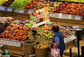 A woman browses in the fruit section of a Loblaw Cos. Ltd. supermarket in Collingwood, Ont.