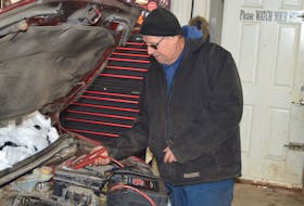 Wade MacKinnon, a mechanic at Shaw’s Towing in Charlottetown, tests a car battery on Feb. 1. Dave Stewart • The Guardian