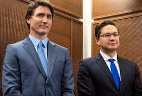 Prime Minister Justin Trudeau stands with Conservative Leader Pierre Poilievre as he waits to speak at a Tamil heritage month reception in Ottawa, January 30, 2023.