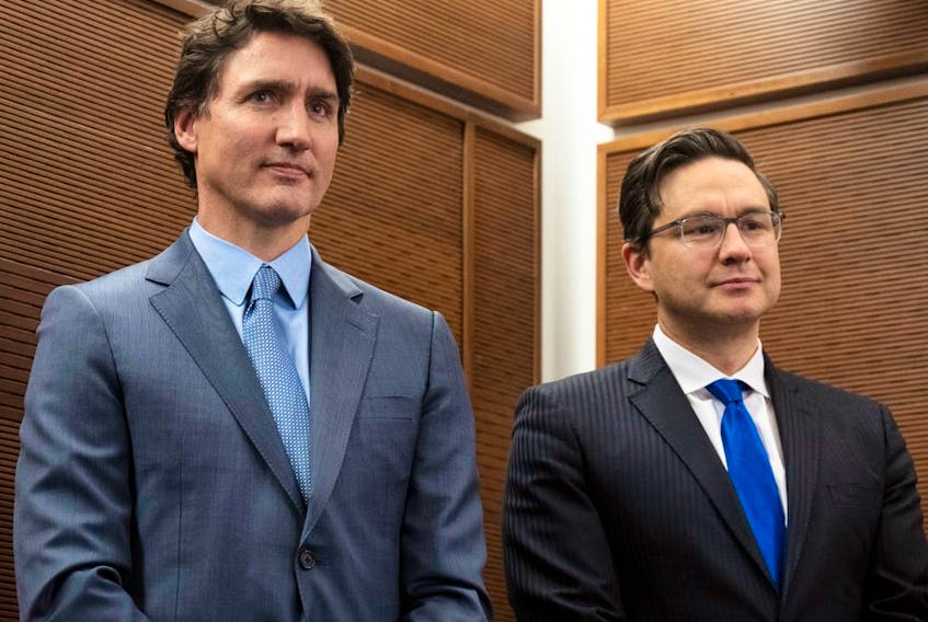 Prime Minister Justin Trudeau stands with Conservative Leader Pierre Poilievre as he waits to speak at a Tamil heritage month reception in Ottawa, January 30, 2023.
