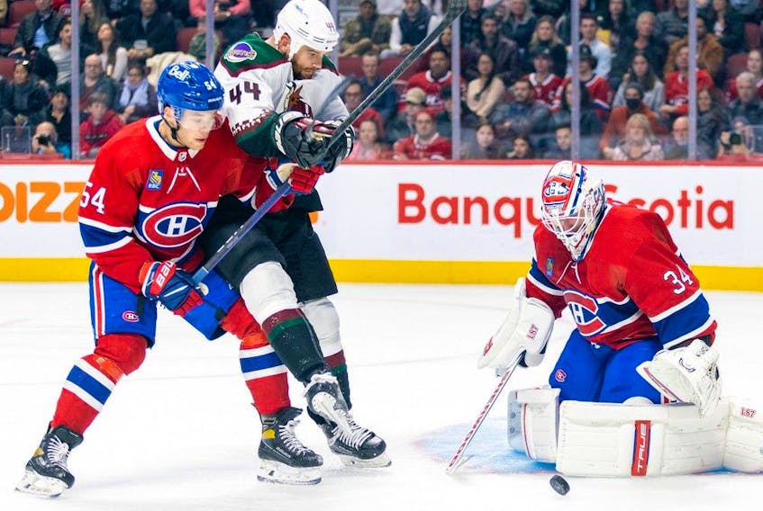 Montreal Canadiens defenceman Jordan Harris ties up Arizona Coyotes' Zack Kassian as Habs goalie Jake Allen makes a save during second period in Montreal on Oct. 20, 2022. 