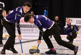 Nova Scotia No. 1 team members Aidan MacDonald (left) and Evan Hennigar sweep skip Nick Mosher's shot during the Canadian under-18 curling championships in Timmins, Ont. - BRIAN CHICK / CURLING CANADA