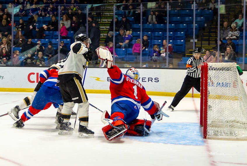 Charlottetown Islanders forward and team captain Keiran Gallant, positioned in front of Moncton Wildcats goaltender Jacob Steinman, tracks the puck on a scoring opportunity as referee Tanner Doiron follows the play. The action took place during a Quebec Major Junior Hockey League (QMJHL) game at Eastlink Centre in Charlottetown on Feb. 12. Gallant scored the winning goal in overtime to give the Islanders a 5-4 win before close to 2,800 fans. Charlottetown Islanders • Special to The Guardian