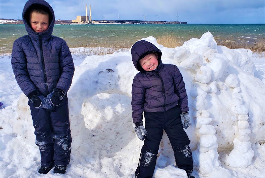 Brothers Issac Smith, left and Brodix Hickey were happy to get their photo taken next to the snow fort the nine-year-old and six-year-old built on Feb. 11 in Dominion. CONTRIBUTED