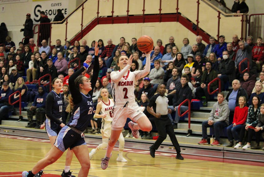 Acadia Axewomen guard Haley McDonald hits the first bucket of the night on Feb. 11, her final home game at Stu Aberdeen Court. McDonald gave the home fans one last star performance to remember her by.  
Jason Malloy
