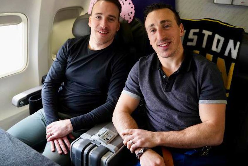 Boston Bruins winger Brad Marchand, right, and his younger brother Jeff enjoy the flight to an NHL game in Dallas. - Boston Bruins