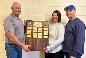 The inaugural P.E.I. School Athletic Association Brodie McCarthy Student-Athlete Award will be presented in June to a Grade 12 student, honouring the memory of McCarthy. PEISAA chair Darryl Boudreau, left, and Brodie’s parents, Lisa and Dave, display the award. PEISAA • Special to The Guardian