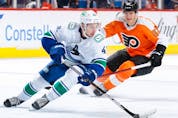  Quinn Hughes #43 of the Vancouver Canucks skates with the puck during the second period against the Philadelphia Flyers at Wells Fargo Center on October 15, 2021 in Philadelphia, Pennsylvania.
