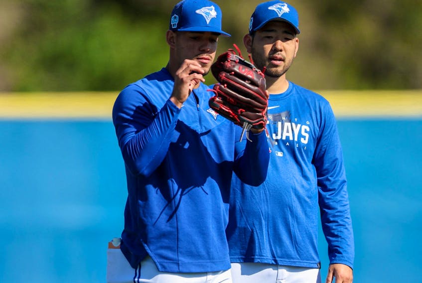 Toronto Blue Jays starting pitcher Jose Berrios (17) and starting pitcher Yusei Kikuchi (16) participate in spring workouts at the Blue Jays Player Development Complex. 