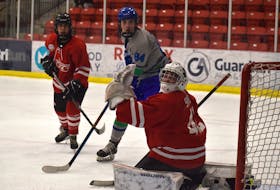Cam MacLean of the Cabot Highlanders, middle, and Cape Breton Jets goaltender Andrew Shimon look on as a puck goes over the net during Nova Scotia Under-16 'AAA' Hockey League action at the Membertou Sport and Wellness Centre on Thursday. Cabot won the game 3-1. JEREMY FRASER/CAPE BRETON POST.