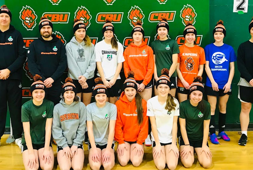 Cape Breton FC's Tier 1 U15 'AAA' girls are pictured with their coaches Damien Barry, Mitch Hanna and Becky Hanna as they help to launch the club's popular new #ForeverOrange toques. CONTRIBUTED/IAIN KING