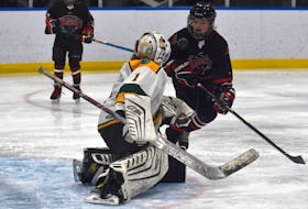 Zach Boutilier of the Glace Bay Miners, right, looks directly at the puck in front of him as Northside Vikings goaltender Linden Howley attempts to keep it out of the net during under-13 ‘A’ Cape Breton Cup hockey action at the Miners Forum in Glace Bay on Thursday. The Miners and Vikings tied 2-2. JEREMY FRASER/CAPE BRETON POST.