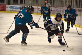 Tyson Demone of the Sydney Steelers, right, works his way past Colton McVarish of the New Waterford Sharks during under-13 ‘B’ Cape Breton Cup hockey action at the Membertou Sport and Wellness Centre on Thursday. Sydney won the game 14-2. JEREMY FRASER/CAPE BRETON POST.