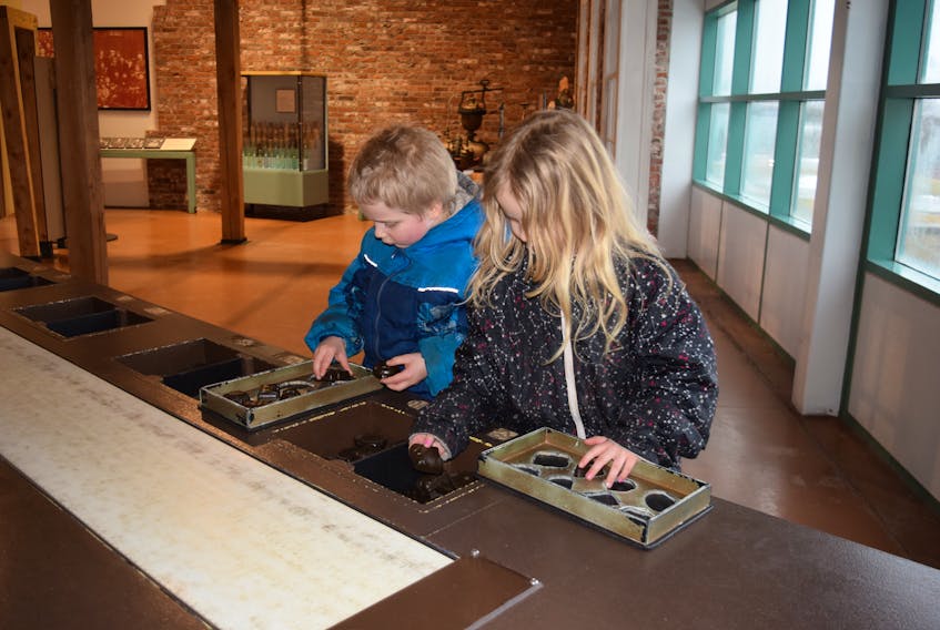 Asher and Ella Brown enjoyed trying out the replica chocolate assembly line at the Museum of Industry. - Adam MacInnis