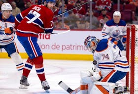 Montreal Canadiens' Kirby Dach looks for a rebound Edmonton Oilers goaltender Stuart Skinner stops Dach's shot during first period in Montreal on Feb. 12, 2023.
