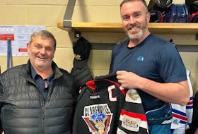 CeeBee Stars forward Keith Delaney (right) is presented with his Clarenville Caribous jersey by Clarenville manager Ivan Hapgood when Delaney made his first trip back to Clarenville earlier this season. Delaney spent a decade with the Caribous before being dealt back to the CeeBees before the start of the 2022-2023 AESHL season. Contributed photo