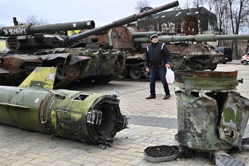 A man looks at destroyed Russian military vehicles and equipment shown in an open air exhibition in the centre of Kyiv on Feb. 24.