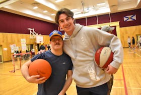 Mariners goalie Joey Lovullo and Gordon Jenkins play some basketball during the weekly Icy Knights program that the team takes part in during their hockey season. TINA COMEAU