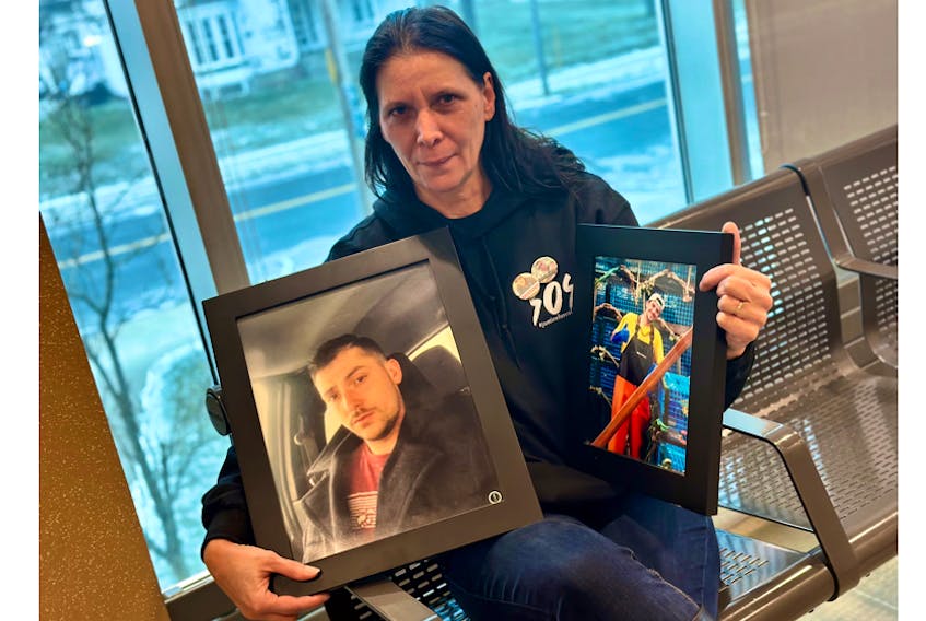 Stacey Cook, the mother of Colton Cook, holds photographs of him on the day Keith Siscoe Jr. was sentenced on a charge of accessory after the fact to murder. TINA COMEAU PHOTO
