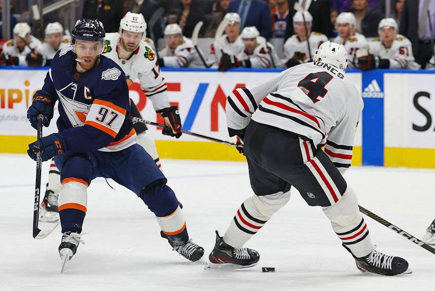  Edmonton Oilers forward Connor McDavid (97) puts the puck through the feet of Chicago Blackhawks defencemen Seth Jones (4) during the first period at Rogers Place Jan 28, 2023. Perry Nelson-USA TODAY Sports