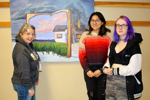 Holland College fundamental arts instructor Kate Sharpley, left, discusses Camila Chalini Blanche's painting with her and student Aly Nemeth. Both students are considering NSCAD’s bachelor of fine arts program. Contributed