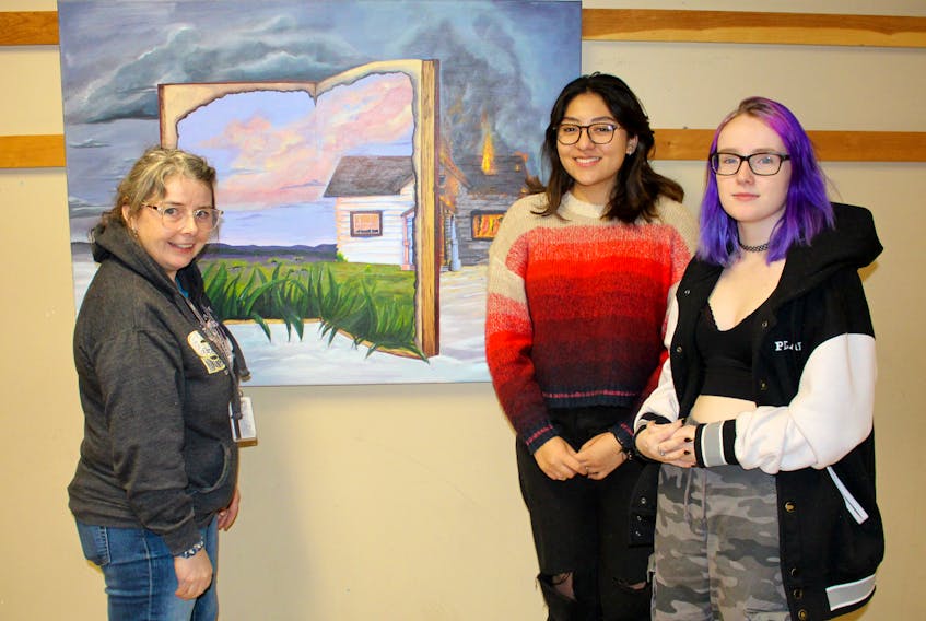 Holland College fundamental arts instructor Kate Sharpley, left, discusses Camila Chalini Blanche's painting with her and student Aly Nemeth. Both students are considering NSCAD’s bachelor of fine arts program. Contributed