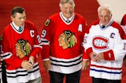  Stan Mikita, from left, Bobby Hull and Henri Richard stand at centre ice as former greats of the Chicago Blackhawks were honoured by the Montreal Canadiens on Jan. 8, 2008, at the Bell Centre in Montreal prior to the game between the Canadiens and Blackhawks.