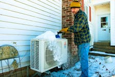 Greg Levy, owner of GForce Mechanical Inc., brushes snow from one of the heat pumps at his Hammonds Plains home on Friday, Feb. 3, 2023.
Ryan Taplin - The Chronicle Herald