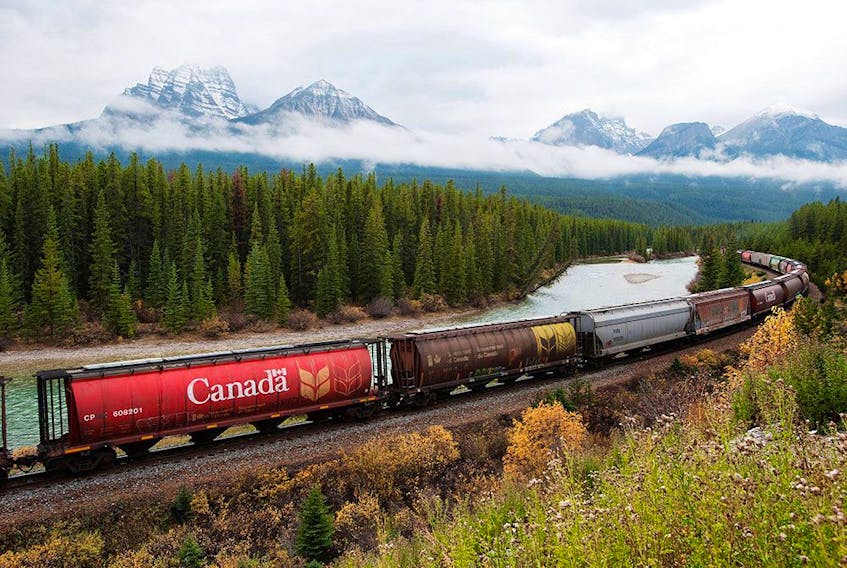 Rail cars loaded with Canadian wheat travel through the Rocky Mountains near Banff, Alberta. Recent reporting by Canadian National Railway Co. and Canadian Pacific Railway Ltd. shows the two companies have moved more than 30 million tonnes of Prairie grain since the summer.