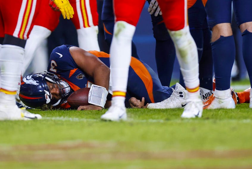 Russell Wilsonof the Denver Broncos lies on the field after sustaining a concussion in the fourth quarter of a game against the Kansas City Chiefs at Empower Field At Mile High on December 11, 2022. 
