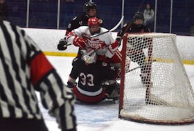Dillon Arsenault of the Riverview Ravens, middle, gets pushed on top of Northumberland Nighthawks goaltender Evan Ramsey during Red Cup Showcase action at the Cape Breton County Recreation Centre in Coxheath on Friday. Riverview won the game 4-3. JEREMY FRASER/CAPE BRETON POST.