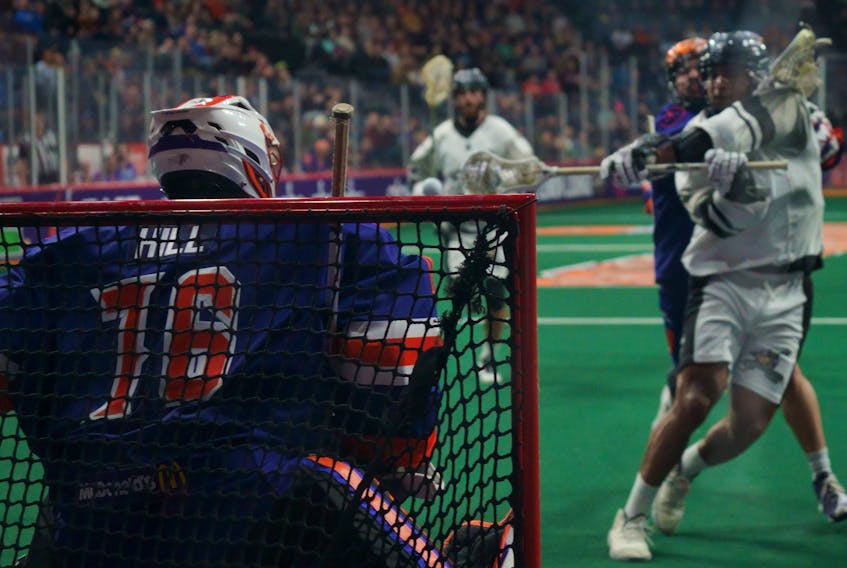 Calgary defender Jeff Cornwall beats Halifax netminder Warren Hill six seconds into overtime as the Roughnecks defeated the Thunderbirds 11-10 in National Lacrosse League play Saturday night at Scotiabank Centre. - NATIONAL LACROSSE LEAGUE
