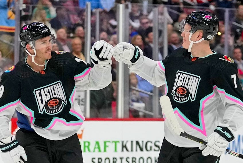 Atlantic Division forward Matthew Tkachuk (19) of the Florida Panthers fist bumps Atlantic Division forward Brady Tkachuk (71) of the Ottawa Senators during the second period of a semifinal game during the 2023 NHL All-Star Game at FLA Live Arena. 