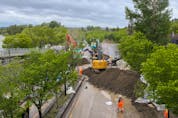  City of Calgary crews build an earth berm across Memorial Drive as flood protection on Tuesday, June 14, 2022.
