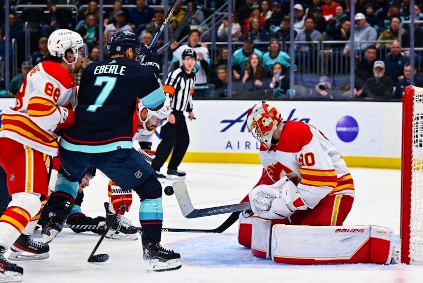  Calgary Flames goaltender Dan Vladar blocks a shot by the Seattle Kraken during the second period at Climate Pledge Arena in Seattle on Jan. 27, 2023.