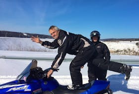 Friends John Forbes, on the snowmobile, and Ray Savage put in thousands of miles together on New Brunswick snowmobile trails. Forbes passed away in September from a cardiac event but had thought he was experiencing COVID-19 symptoms. CONTRIBUTED