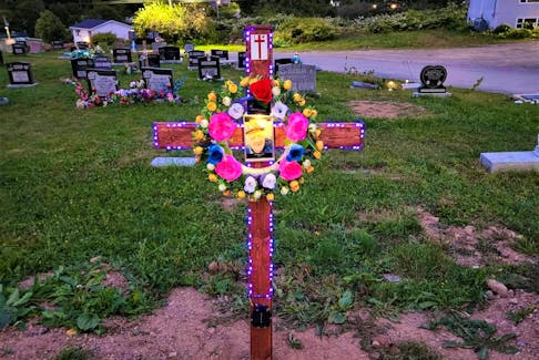 One of the wooden crosses made by Stephen Francis and his crew, adorned with solar lights, which mark graves at Holy Family Parish Church in Eskasoni. CONTRIBUTED