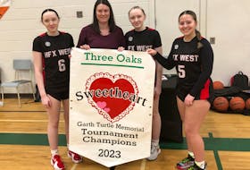 Kristen Turtle, second left, presented the championship banner for the Garth Turtle Memorial Sweetheart basketball tournament to the captains of the Halifax West Warriors, from left, Emma Cameron, tournament most valuable player Mya Cameron and Jayah Sapp. Halifax West defeated Parkview Educational Centre 81-44 in an all-Nova Scotia final of the senior AAA girls’ event in Summerside on Feb. 4. Turtle, a resident of Halifax, is the daughter of Garth Turtle and a former basketball player at host Three Oaks Senior High School. Jason Simmonds • The Guardian