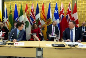 Quebec Premier Francois Legault sits beside Prime Minister Justin Trudeau as Canada's premiers meet in Ottawa on Tuesday, Feb. 7, 2023 in Ottawa. Minister of Finance Chrystia Freeland and Minister of Health Jean-Yves Duclos sit behind.