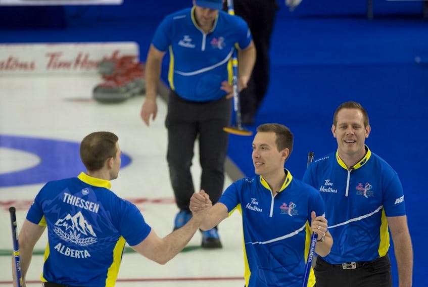  Alberta skip Brendan Bottcher celebrates with second Brad Thiessen (left) and lead Karrick Martin, with third Darren Moulding in the background, after defeating Wild Card 3 during the Tim Hortons Brier at the Markin MacPhail Centre in Calgary on March 8, 2021.