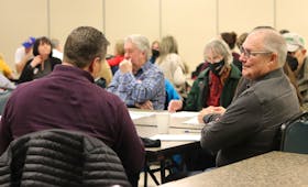Attendees at a public engagement session for the planned overdose prevention site in Charlottetown talk after a presentation from Shawn Martin, provincial harm reduction co-ordinator, at the Murchison Centre on Feb. 8. - Logan MacLean