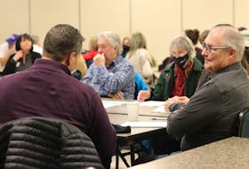 Attendees at a public engagement session for the planned overdose prevention site in Charlottetown talk after a presentation from Shawn Martin, provincial harm reduction co-ordinator, at the Murchison Centre on Feb. 8. - Logan MacLean