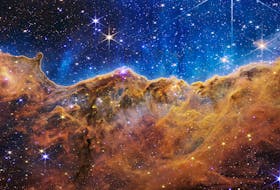 The star-forming Cosmic Cliffs region in the Carina Nebula — roughly 7,600 light-years away from Earth, as captured by NASA’s James Webb Space Telescope. The cycle of stellar birth and death has seeded the cosmos with the elemental material that, through countless recyclings, has formed new stars, including our own solar system. Photo courtesy of NASA’s Image and Video Library